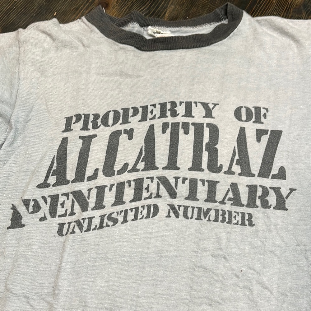 Vintage ‘Property of Alcatraz’ ringer T. Women’s small vintage fit. Gray/ blk